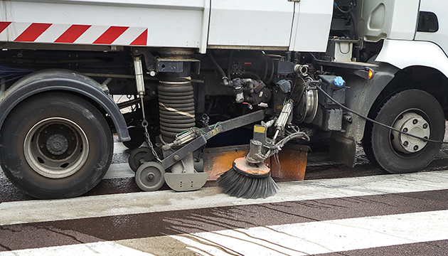 image of street sweeping truck cleaning a road