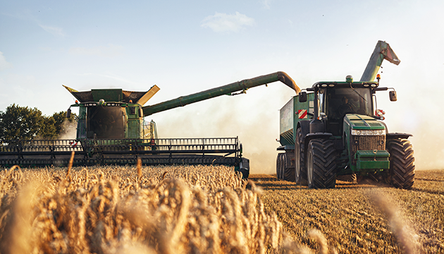 image of tractor and agricultural equipment in a field
