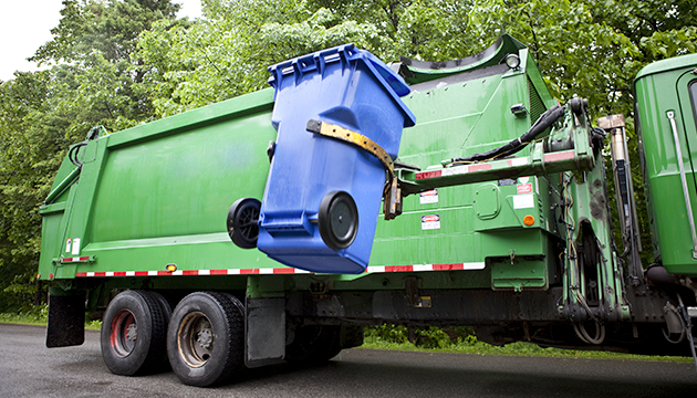image of garbage truck picking up refuse